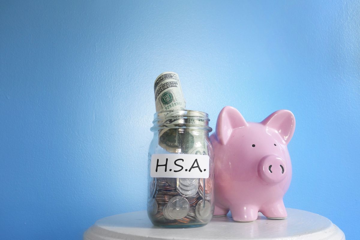 HSA funds in a piggy bank and glass jar