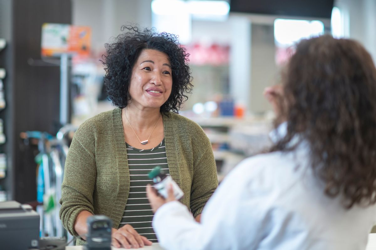 Woman talking to pharmacist about the Medicare prescription payment plan