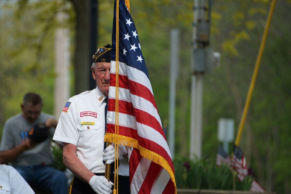 Veteran with Medicare holding American flag